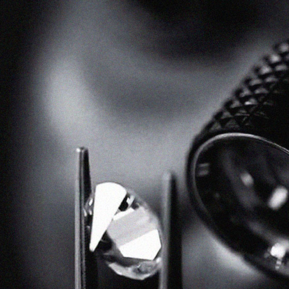 Inspecting diamond with a loupe | Facets Singapote
